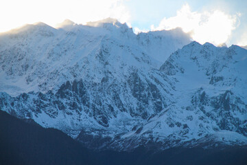 Jagged, snowy peaks loom under a cloudy sky Meili Snow Mountain Yala Snow Mountain, Sichuan, China