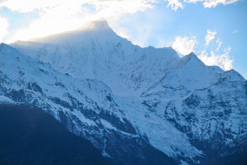 Jagged, snowy peaks loom under a cloudy sky Meili Snow Mountain Yala Snow Mountain, Sichuan, China