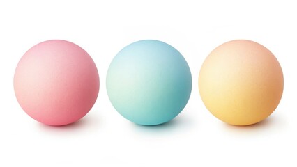 Three pastel colored easter eggs lined up against a white background in a studio setting