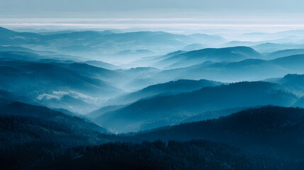 Obraz premium Deep blue mountain range layers shrouded in atmospheric haze mountains landscape