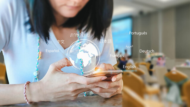 A woman uses her mobile phone for language translation. A digital globe and different languages are displayed above the screen, showing modern communication technology. - Powered by Adobe