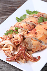 Grilled Stuffed Squid with garlic and pork. Thai style isolate on white plate