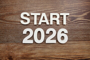 Start 2026 alphabet letters on wooden background