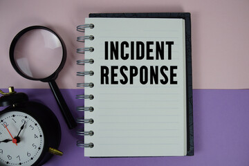 Incident Response text written on notebook paper with magnifying glass and alarm clock