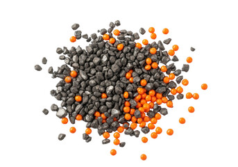 Extreme macro shot of irregular charcoal grey iron filings and distinct bright orange plastic granules scattered on a transparent background, concept of industrial remnants