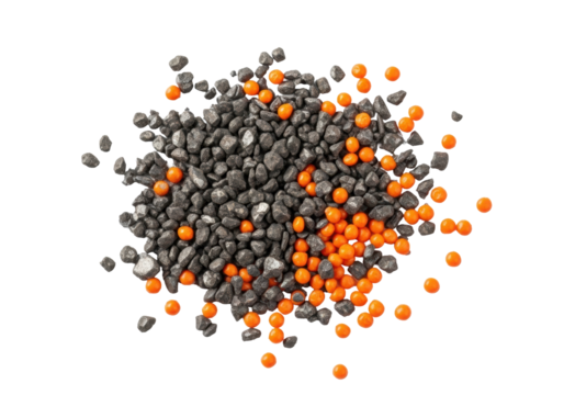 Extreme macro shot of irregular charcoal grey iron filings and distinct bright orange plastic granules scattered on a transparent background, concept of industrial remnants