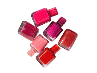 A cluster of various shades of pink and red nail polish bottles