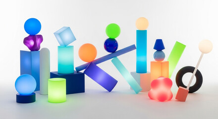 A vibrant collection of illuminated, abstract shapes and forms arranged against a neutral backdrop, showcasing a spectrum of colors and textures, creating a visually engaging composition.