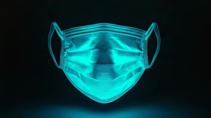 Glowing medical face mask floating on dark background - Powered by Adobe