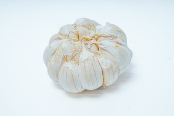 close up view of fresh whole garlic isolated in white for advertising space.