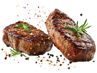 Two grilled steaks, browned and seasoned, with sprigs of fresh rosemary.  A scattering of pepper and spice surrounds the steaks © Ajinomoto