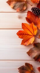 Flat lay of orange and red autumn leaves with pinecones on light wood planks, minimalist seasonal design for a clean fall banner with copy space
