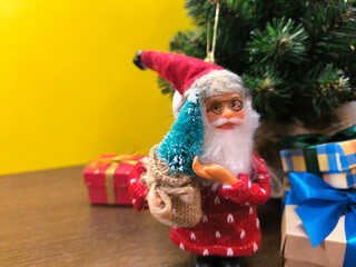 New Year Santa Claus near the Christmas tree.