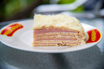 Delicious savory appetizer made from thin pastry sheets filled with ham, cheese, and sour cream, perfect for parties, celebrations, and family gatherings.