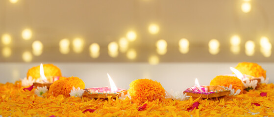 Diwali Festival. Beautifully arranged oil lamps and marigold flowers for celebration.