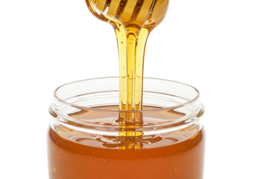 Honey pouring into glass jar golden syrupy texture transparent background