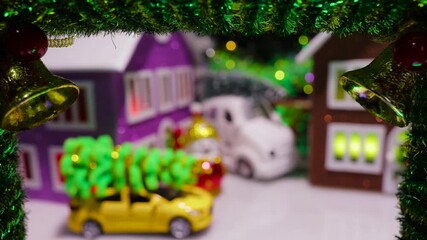 In the middle of the Christmas wreath with bells is a half-blurred Christmas village