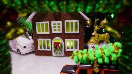 In the middle of the Christmas wreath with bells is a Christmas village with cars