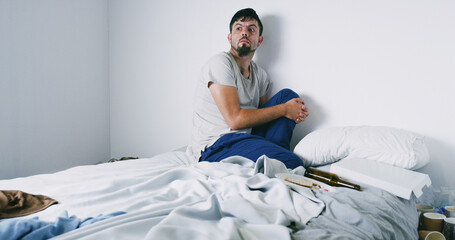 Addiction, drugs and man with anxiety on bed with panic, psychosis and loss of appetite. Mockup...