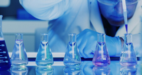 Chemical, beaker and pipette with hands of man in lab for forensic pathologist, research or sample analysis. Toxicology exam, medical study and liquid with scientist and dropper for drug screening