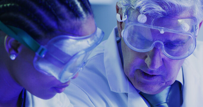 Lab, scientists and team with goggles, medical research and forensic analysis with UV light and ppe. Colleagues, safety and people with eyewear to block fluorescence, collaboration and biotechnology