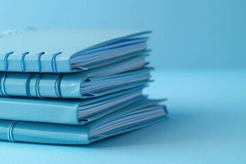 High Quality Visual of Stack of Blue Notebooks with Notepad on Top
