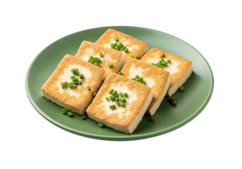 Golden-brown, crispy tofu squares, garnished with fresh chives, on a vibrant green plate, presented against a stark black backdrop.