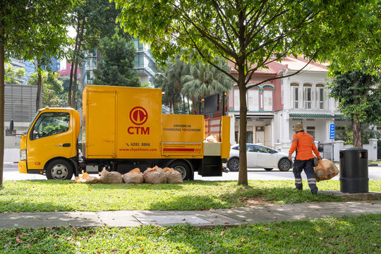 Singapore, Singapore - May 01, 2025: Yellow CTM waste collection truck parked on Road, Singapore