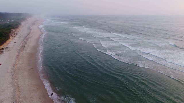 aerial view of waves rolling along the sandy shoreline of maceda beach in s pedro ovar portugal