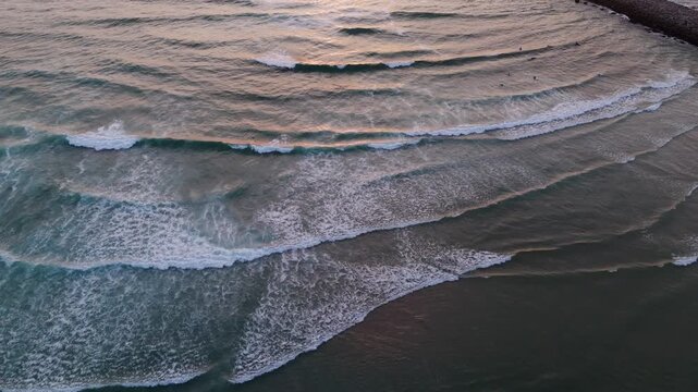 aerial view of ocean waves breaking at maceda beach in s pedro ovar portugal during sunset