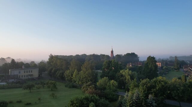 Church in the fog dawn in Krakes Lithuania