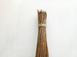 closeup of broom stick, concept, tool for sweeping rough surfaces or outdoors, broom made from coconut tree fronds. isolated white background