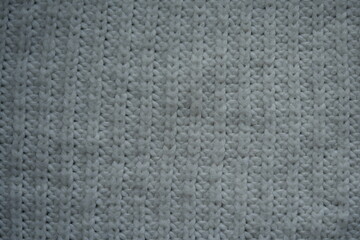 beige acrylic textile background beige knitted wool fabric texture close-up macro texture of beige knitted wool fabric as a background. soft yarn surface with smooth symmetrical knit pattern