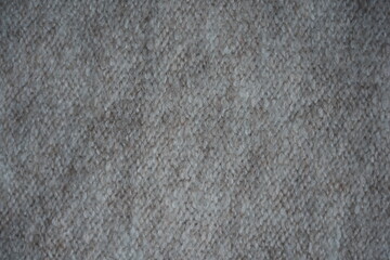 beige acrylic textile background beige knitted wool fabric texture close-up macro texture of beige knitted wool fabric as a background. soft yarn surface with smooth symmetrical knit pattern