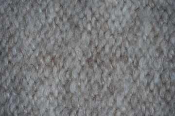 beige acrylic textile background beige knitted wool fabric texture close-up macro texture of beige knitted wool fabric as a background. soft yarn surface with smooth symmetrical knit pattern