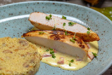 Couscous with chicken fillet in a blue plate in a macro photo
