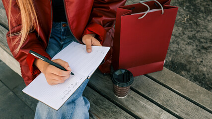 Woman writing in a notebook outdoors