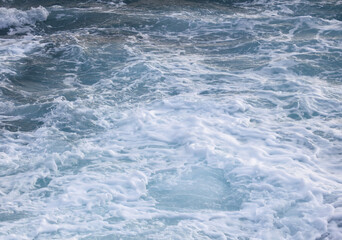 A large body of water with a lot of foam and bubbles