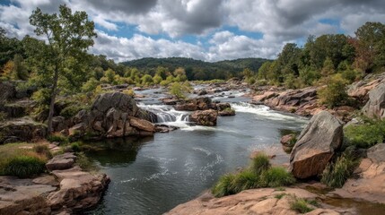 River flows over rocks surrounded by trees under a cloudy sky.