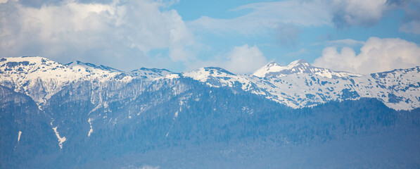 The mountains are covered in snow and the sky is blue