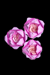 Origami is a traditional Japanese paper craft in which colored and patterned paper is folded into shapes such as animals and flowers. This piece is a lotus flower.