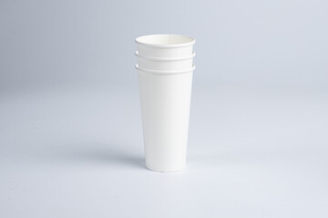 Three 20 oz paper cups stacked in a vertical row on a white background.