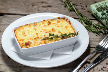 Cheese casserole in a ceramic dish on a wooden table