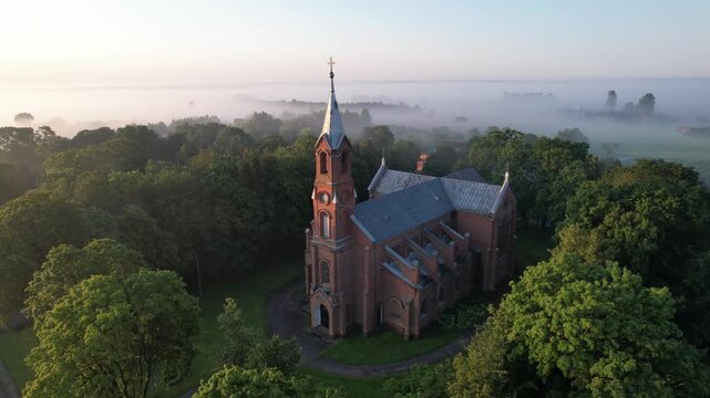 Church in the fog dawn in Krakes Lithuania