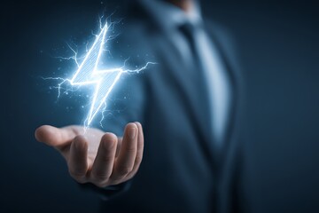 Businessman holding glowing blue lightning bolt in his hand