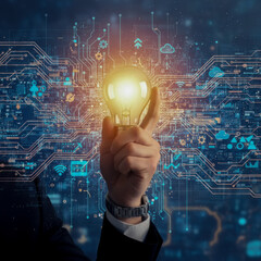 A hand holding a glowing light bulb with a circuit board design in the background, symbolizing ideas and technology.