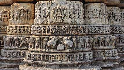 Hindu deity, elephant, and Kirtimukha relief carvings on Gurjjar Dev Temple's panels in Dwarahat, Uttarakhand, India.