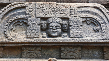 Exquisite sculpture of human faces on the Dandeshwar Temple, dedicated to Lord Shiva, located in Jageshwar, Uttarakhand, India.
