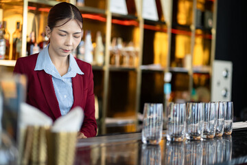 Asia woman cleaning a glass at bar	