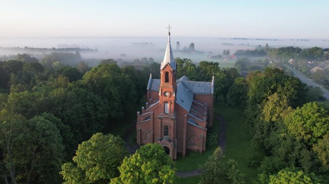 Church in the fog dawn in Krakes Lithuania